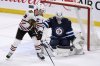 Winnipeg Jets' goaltender Connor Hellebuyck (37) makes a save on Chicago Blackhawks' Jonathan Toews (19) during third period NHL action in Winnipeg on Sunday, Feb. 16, 2020. Toews is the newest member of the Jets after signing a one-year deal with the team after not playing for two full seasons. THE CANADIAN PRESS/Fred Greenslade
