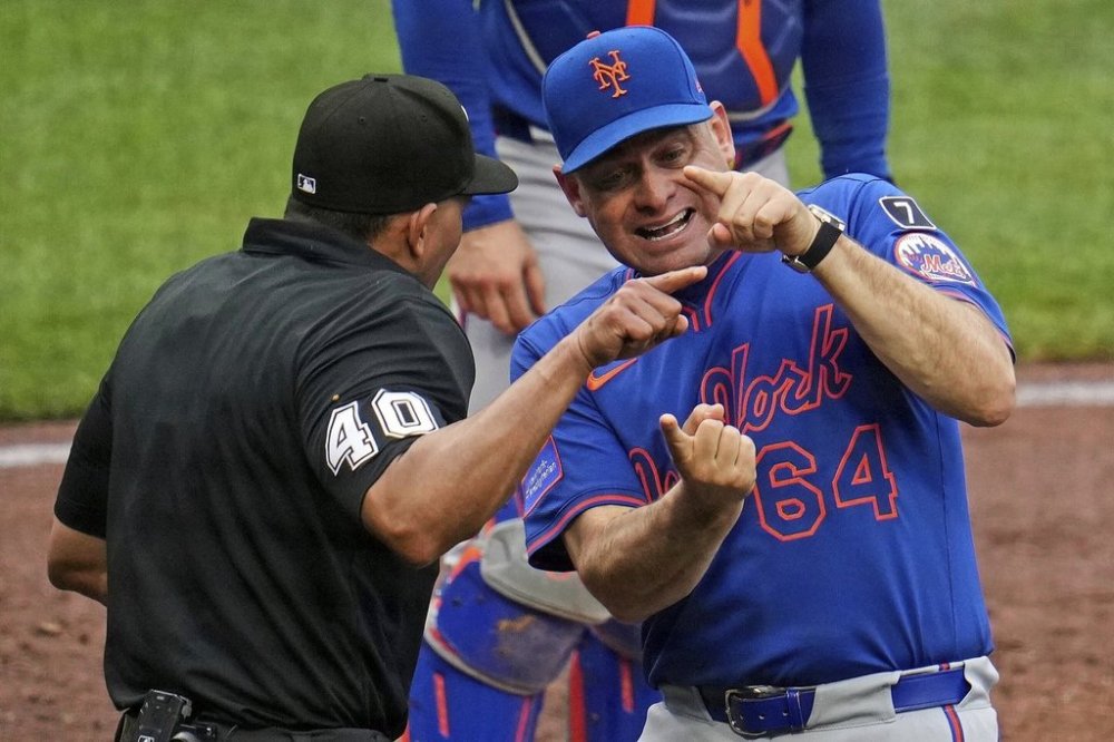 New York Mets manager Carlos Mendoza (64) makes his point to home plate umpire Roberto Ortiz (40) during the fourth inning of a baseball game against the Pittsburgh Pirates in Pittsburgh, Saturday, June 28, 2025. (AP Photo/Gene J. Puskar)