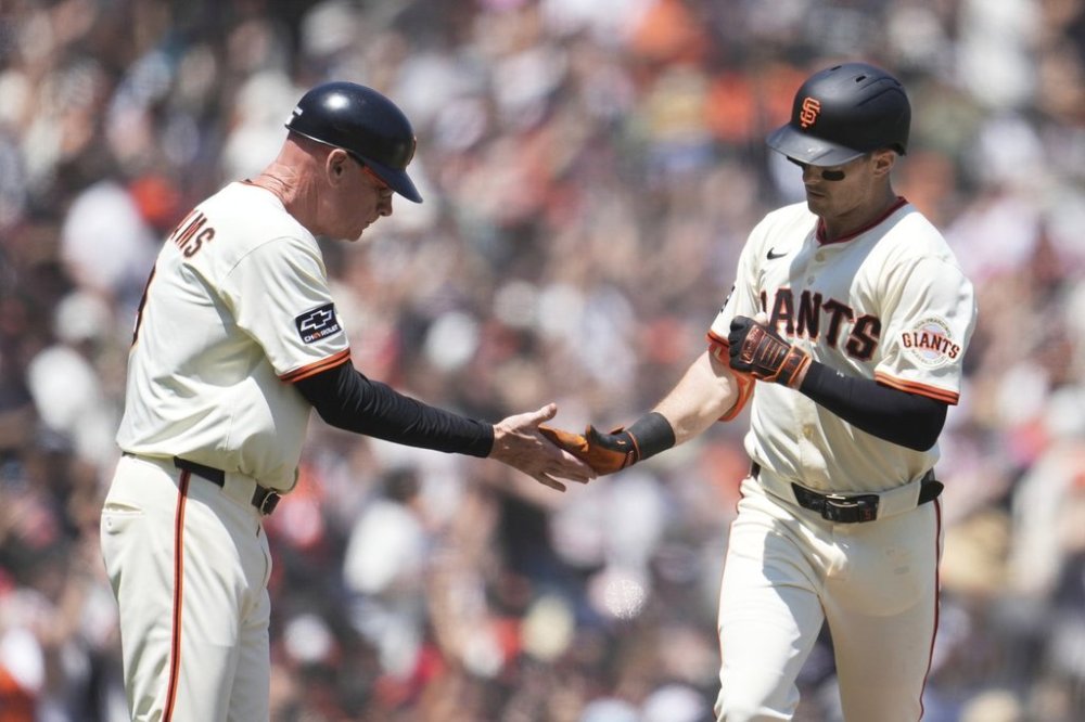 San Francisco Giants' Mike Yastrzemski, right, is congratulated by third base coach Matt Williams after hitting a home run during the fifth inning of a baseball game against the Boston Red Sox in San Francisco, Sunday, June 22, 2025. (AP Photo/Jeff Chiu)