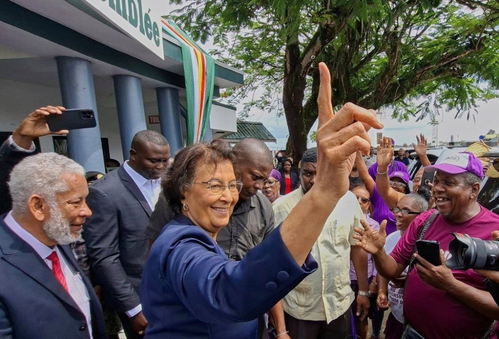 Dr. Jennifer Geerlings-Simons, center, greets people in Paramaribo, Suriname, Sunday, July 6, 2025, after parliament appointed her as the country's first female president. (AP Photo/Bentik Paulus)