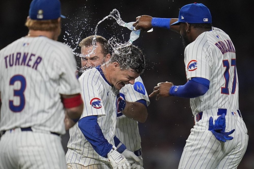 Chicago Cubs' Matt Shaw, center front, is doused after hitting a walkoff home run in the 10th inning to win a baseball game against the Cleveland Guardians, Thursday, July 3, 2025, in Chicago. (AP Photo/Erin Hooley)
