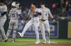 Colorado Rockies catcher Hunter Goodman (15), Orlando Arcia (11) and Michael Toglia (4) celebrate after a baseball game against the Washington Nationals, Monday, June 16, 2025, in Washington. (AP Photo/Nick Wass)