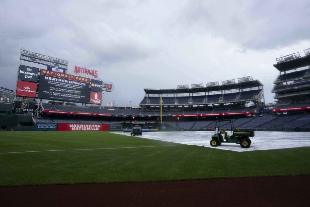 A message on the jumbotron announces the baseball game between the Detroit Tigers and the Washington Nationals is postponed due to weather at Nationals Park, Tuesday, July 1, 2025, in Washington. (AP Photo/Jess Rapfogel)