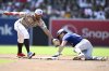 Texas Rangers' Evan Carter, right, steals second base ahead of a tag by San Diego Padres shortstop Xander Bogaerts, left, during the second inning of a baseball game Friday, July 4, 2025. (AP Photo/Denis Poroy)