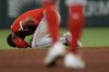 Los Angeles Angels second baseman Christian Moore (4) is helped after being injured fielding a ball hit by Atlanta Braves' Ozzie Albies in the sixth inning of a baseball game, Wednesday, July 2, 2025, in Atlanta. (AP Photo/Mike Stewart)