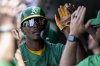 Athletics' Denzel Clarke celebrates in the dugout after scoring during the second inning of a baseball game against the Baltimore Orioles Sunday, June 8, 2025, in West Sacramento, Calif. (AP Photo/Sara Nevis)