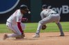 Cleveland Guardians' Angel Martinez, left, slides safely into second base as Detroit Tigers' Colt Keith waits for the throw during the seventh inning of a baseball game, Sunday, July 6, 2025, in Cleveland. (AP Photo/Phil Long)