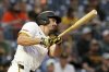 Pittsburgh Pirates' Bryan Reynolds hits an RBI triple during the third inning of a baseball game against the Miami Marlins, Monday, June 9, 2025, in Pittsburgh. (AP Photo/Matt Freed)
