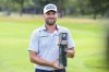 Britain's Daniel Brown poses with the winner's trophy for the European Tour - International Golf Open in Munich, Germany, Sunday, July 6, 2025. (Harry Langer/dpa via AP)