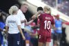 Denmark head coach Andree Jeglertz, left, speaks to Denmark's Pernille Harder during the Euro 2025, group C, soccer match between Denmark and Sweden at Stade de Geneve in Geneva, Switzerland, Friday, July 4, 2025. (AP Photo/Alessandra Tarantino)