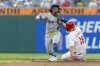 Philadelphia Phillies' Buddy Kennedy (19) is forced out at second as New York Mets second baseman Luisangel Acuna (2) throws to first in the third inning of a baseball game, Sunday, June 22, 2025, in Philadelphia. (AP Photo/Laurence Kesterson)
