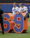 Jack DiLauro, right, and Ron Taylor, left, get ready to take a team photo during a ceremony to honor the 1969 New York Mets before a baseball game against the Atlanta Braves, Saturday, June 29, 2019, in New York. (AP Photo/Frank Franklin II)