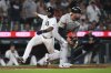 Detroit Tigers' Gleyber Torres, left, scores around Athletics catcher Austin Wynns, right, in the eighth inning during a baseball game, Tuesday, June 24, 2025, in Detroit. (AP Photo/Paul Sancya)