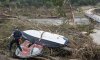 First responders from College Station Fire Department search along the banks of the Guadalupe River, as rescue efforts continue following extreme flooding, Sunday, July 6, 2025, in Ingram, Texas. (AP Photo/Rodolfo Gonzalez)