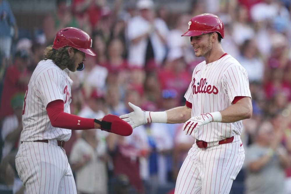 Philadelphia Phillies' Max Kepler, right, and Alec Bohm celebrate after Kepler's two-run home run during the fourth inning in the second baseball game of a doubleheader against the San Diego Padres Wednesday, July 2, 2025, in Philadelphia. (AP Photo/Matt Slocum)