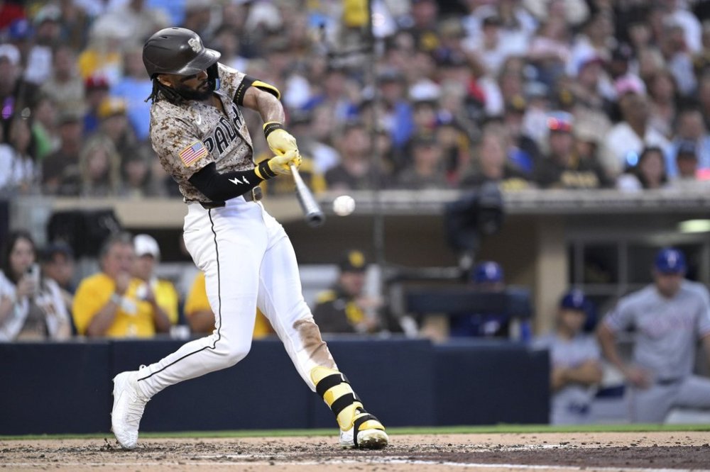 San Diego Padres' Fernando Tatis Jr. hits an RBI double during the fourth inning of a baseball game against the Texas Rangers, Sunday, July 6, 2025, in San Diego. (AP Photo/Orlando Ramirez)