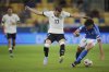 Germany's Brajan Gruda, center, duels for the ball with Italy's Matteo Ruggeri during a quarter final soccer match between Germany and Italy at the European U-21 Championship at the DAC Arena in Dunajska Streda, Slovakia, Sunday, June 22, 2025. (AP Photo/Petr David Josek)