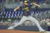 Milwaukee Brewers starting pitcher Brandon Woodruff (53) aims a pitch during the second inning of a baseball game against the Miami Marlins, Sunday, July 6, 2025, in Miami. (AP Photo/Marta Lavandier)
