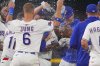 Texas Rangers' Adolis García, center right, covers his face as teammates celebrate after his single that scored Evan Carter during the 11th inning of a baseball game against the Chicago White Sox, Saturday, June 14, 2025, in Arlington, Texas. (AP Photo/LM Otero)