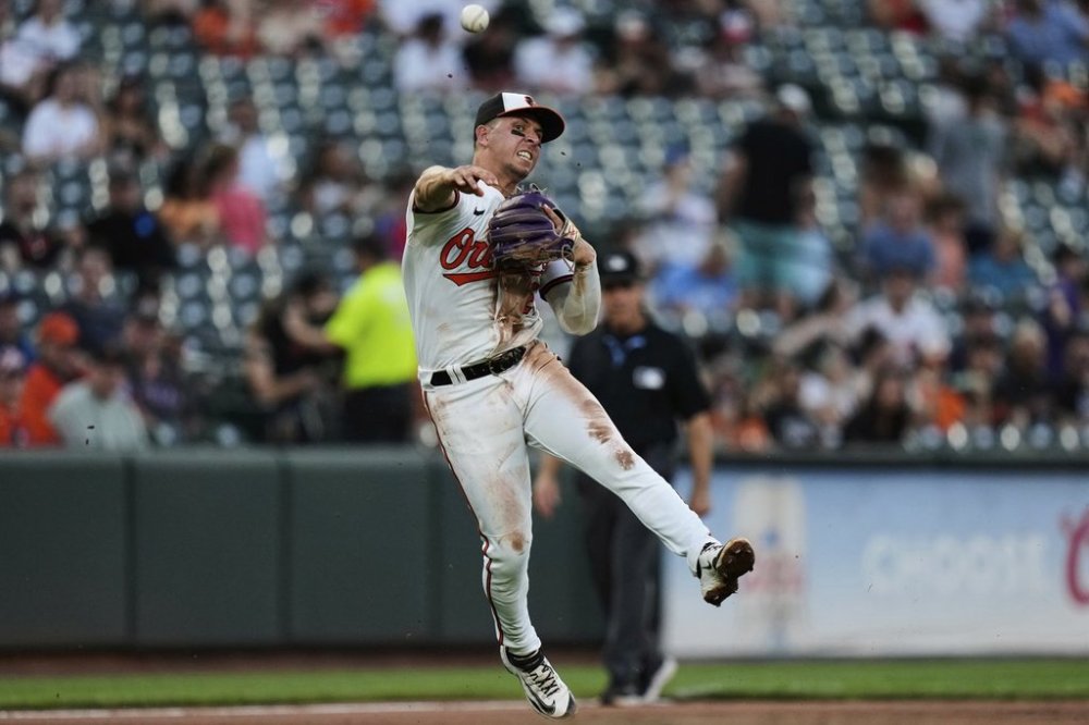 Baltimore Orioles third baseman Ramon Urias throws a ground ball hit by Texas Rangers' Marcus Semien to first baseman Coby Mayo for the out at first base during the fifth inning of a baseball game, Tuesday, June 24, 2025, in Baltimore. (AP Photo/Stephanie Scarbrough)