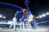 Toronto Blue Jays' George Springer (right) is doused by teammates after defeating the New York Yankees, in Toronto on Thursday, July 3, 2025. THE CANADIAN PRESS/Thomas Skrlj
