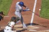 Texas Rangers' Marcus Semien (2) drives in a run with a sacrifice fly off Pittsburgh Pirates pitcher Mitch Keller during the sixth inning of a baseball game in Pittsburgh, Saturday, June 21, 2025. (AP Photo/Gene J. Puskar)