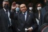 FILE - Former Italian Premier Silvio Berlusconi waves to reporters as he arrives at the Chamber of Deputies to meet Mario Draghi, in Rome, Feb. 9, 2021. Berlusconi is a Serie A owner again after his Monza club won a Serie B playoff Sunday to reach the top division. (AP Photo/Alessandra Tarantino, File)