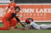 Los Angeles Angels' Zach Neto attempts to steal second base and is tagged out by Baltimore Orioles shortstop Gunnar Henderson during the eighth inning of a baseball game in Baltimore, Saturday, June 14, 2025. (AP Photo/Terrance Williams)
