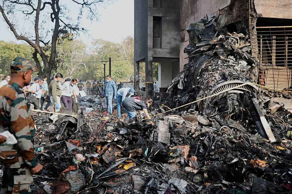 Rescuers work at the site of an airplane that crashed in India's northwestern city of Ahmedabad in Gujarat state, Thursday, June 12, 2025. (AP Photo/Ajit Solanki)