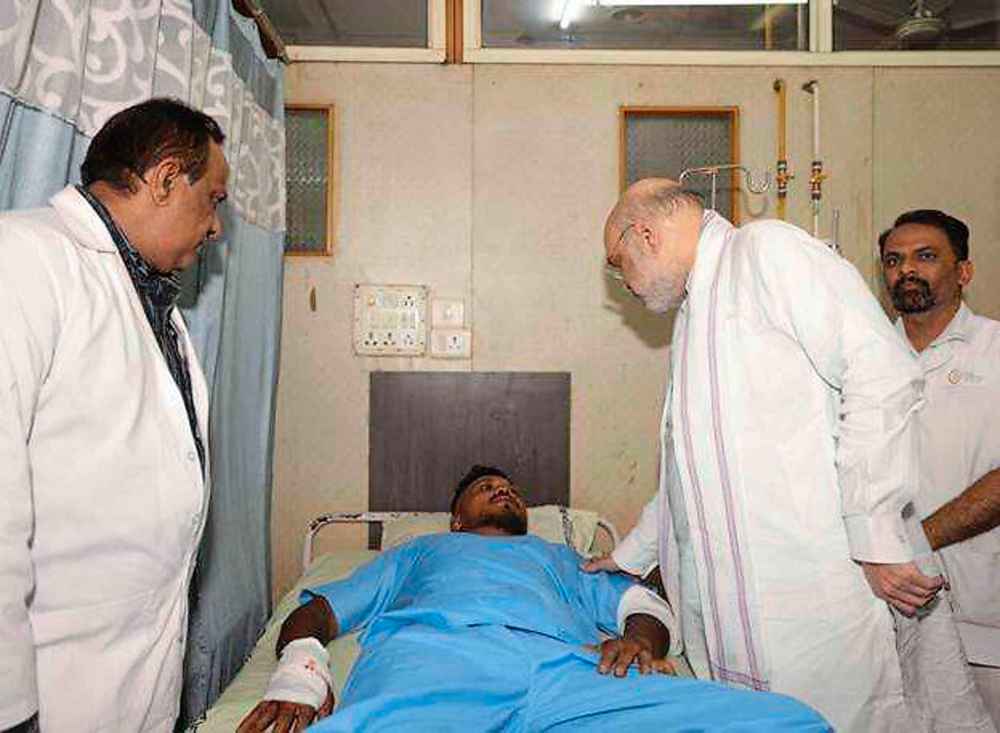 Home Affairs Minister Amit Shah meets British plane crash survivor Vishwash Kumar Ramesh, 40, at a hospital in Ahmedabad. Air India confirmed Mr Ramesh was the sole survivor of the 242 people on board the London-bound Boeing 787 Dreamliner when it crashed into a medical college shortly after take-off from Ahmedabad airport. (Ministry of Home Affairs India via AP)