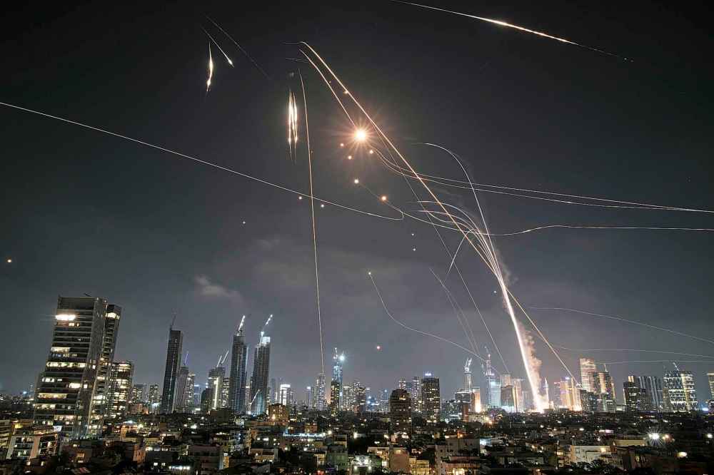 Israeli Iron Dome air defense system fires to intercept missiles over Tel Aviv, Israel, Friday, June 13, 2025. (AP Photo/Leo Correa)
