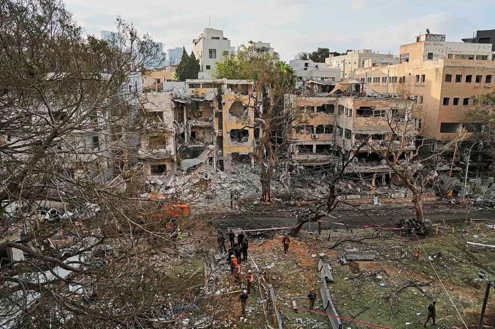 Rescue team work at the site where a missile launched from Iran struck Tel Aviv, Israel, Monday, June 16, 2025. (AP Photo/Baz Ratner)