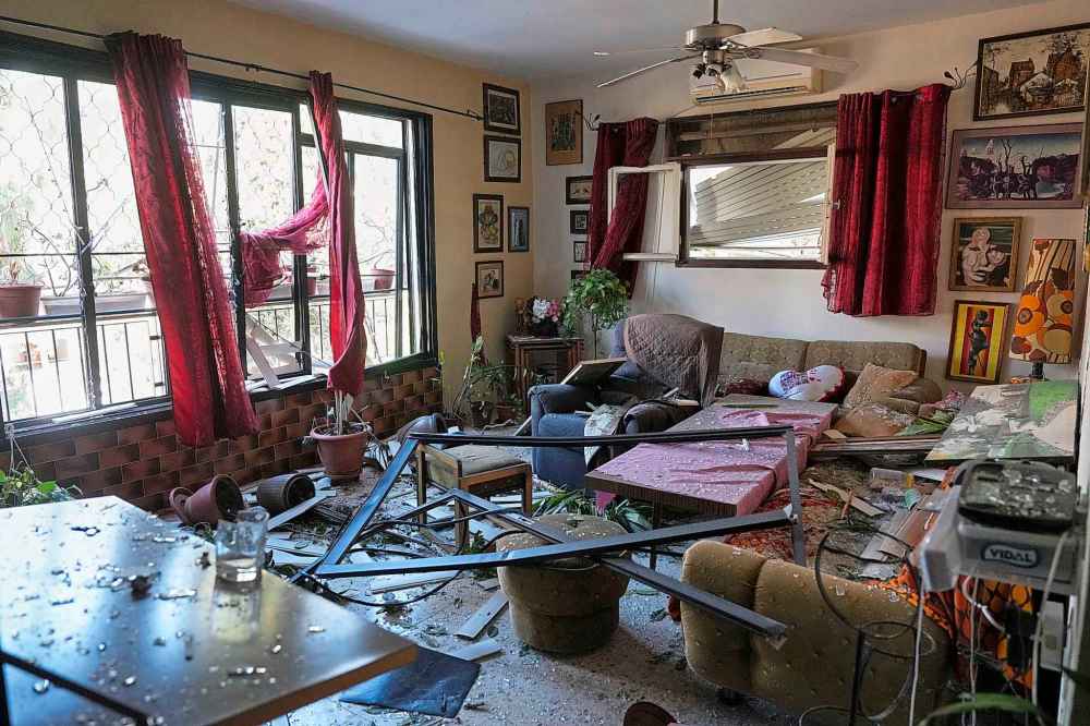A damaged apartment is seen near the site where an Iranian missile struck in Haifa, Israel, Monday, June 16, 2025. (AP Photo/Ariel Schalit)