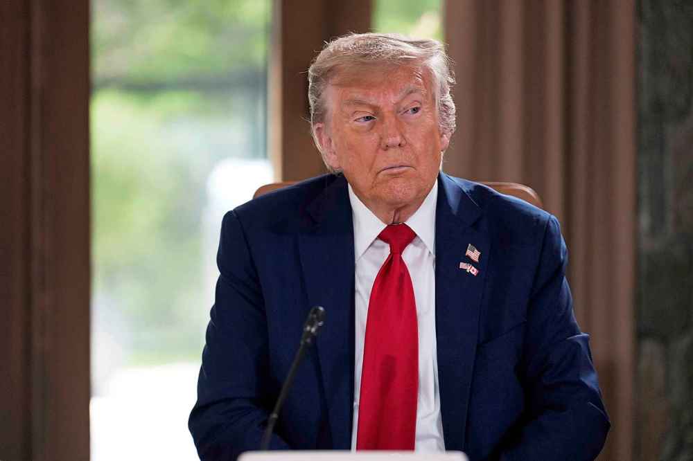 U.S. President Donald Trump sported a lapel pin with Canadian and American flags at the summit. (AP Photo/Mark Schiefelbein)