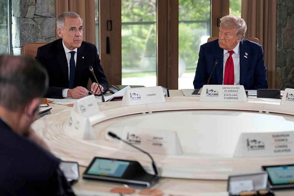 President Donald Trump, right, and Canada's Prime Minister Mark Carney participate in a session of the G7 Summit, Monday, June 16, 2025, in Kananaskis, Canada. (AP Photo/Mark Schiefelbein)