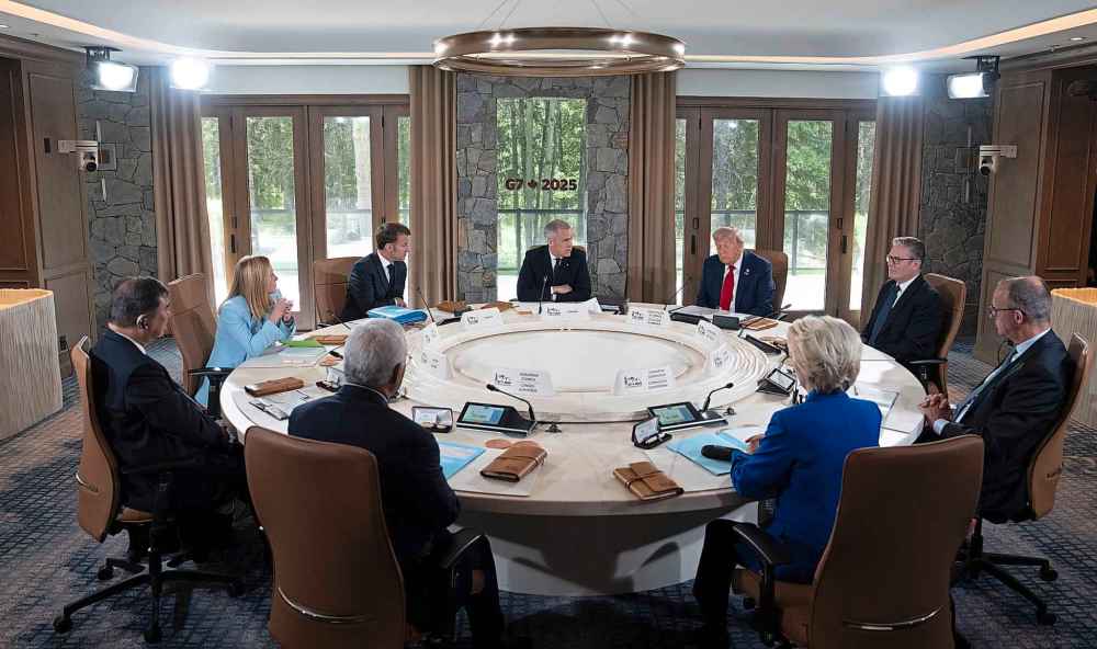 Prime Minister Mark Carney, back centre, delivers opening remarks at the first session of the G7 Summit in Kananaskis, Alta., on Monday, June 16, 2025. THE CANADIAN PRESS/Adrian Wyld