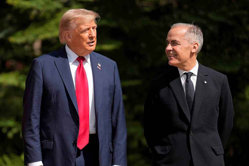 Canada's Prime Minister Mark Carney, right, greets President Donald Trump during the official welcome of the G7 Summit, Monday, June 16, 2025, in Kananaskis, Canada. (AP Photo/Mark Schiefelbein)