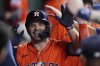 Houston Astros designated hitter Jose Altuve is congratulated in the dugout after hitting a solo home run during the fourth inning of a baseball game against the Minnesota Twins, Friday, June 13, 2025, in Houston. (AP Photo/Kevin M. Cox)