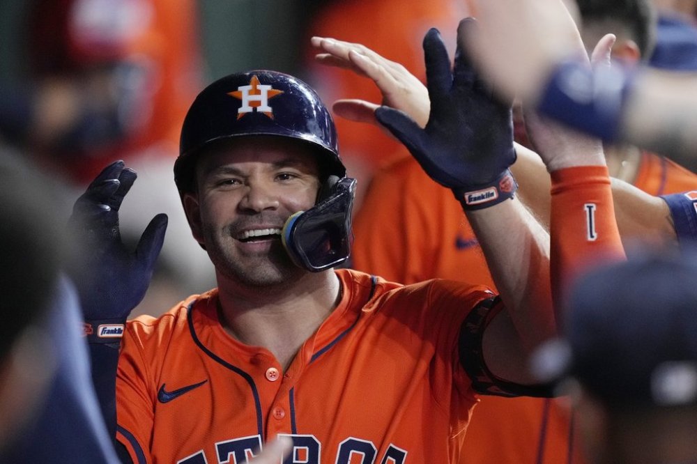 Houston Astros designated hitter Jose Altuve is congratulated in the dugout after hitting a solo home run during the fourth inning of a baseball game against the Minnesota Twins, Friday, June 13, 2025, in Houston. (AP Photo/Kevin M. Cox)