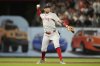 Boston Red Sox third baseman Marcelo Mayer throws out San Francisco Giants' Wilmer Flores at first base during the seventh inning of a baseball game in San Francisco, Friday, June 20, 2025. (AP Photo/Jeff Chiu)