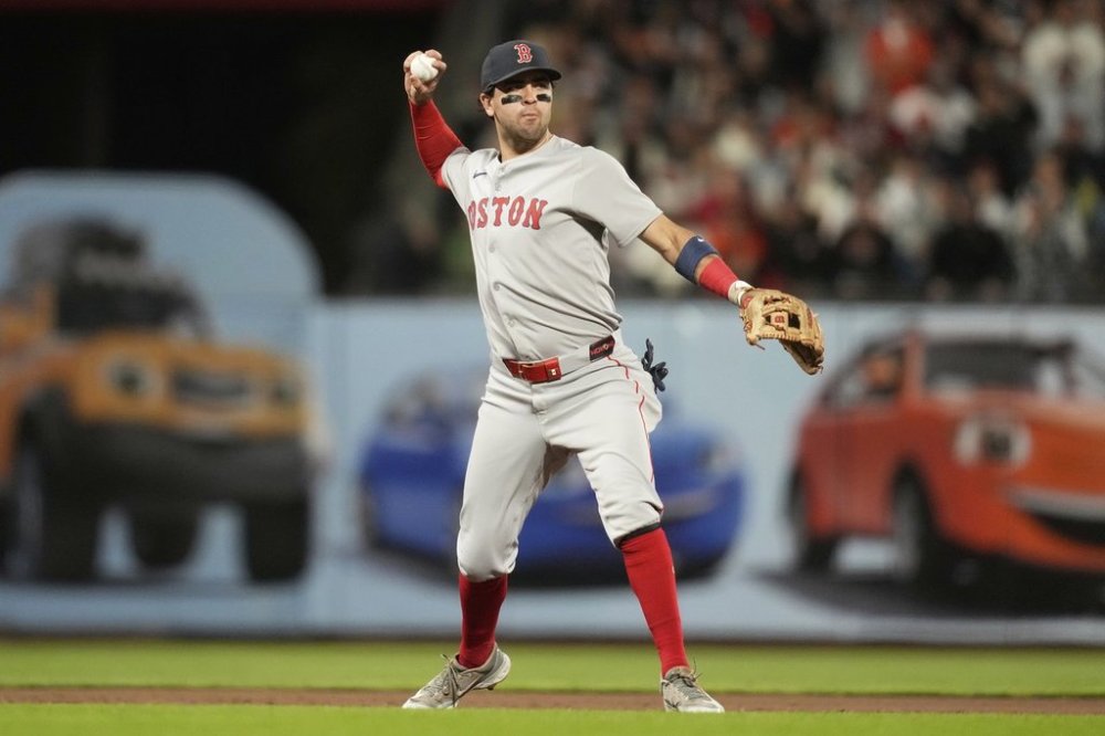 Boston Red Sox third baseman Marcelo Mayer throws out San Francisco Giants' Wilmer Flores at first base during the seventh inning of a baseball game in San Francisco, Friday, June 20, 2025. (AP Photo/Jeff Chiu)