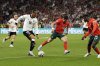 Germany's Leroy Sane tries to drive the ball past Portugal's Pedro Neto and Nuno Mendes, right, during the Nations League semifinal soccer match between Portugal and Germany at the Munich Football Arena, in Munich, Germany, Wednesday, June 4, 2025. (AP Photo/Martin Meissner)