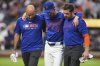 New York Mets pitcher Griffin Canning is helped off the field by head athletic trainer Joseph Golia, right, and assistant athletic trainer Bryan Baca during the third inning of a baseball game against the Atlanta Braves Thursday, June 26, 2025, in New York. (AP Photo/Frank Franklin II)