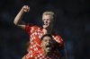 Mainz' scorer Jonathan Burkardt, top, celebrates their side's third goal during the German Bundesliga soccer match between VfL Bochum, and FSV Mainz 05 in Bochum, Germany, Saturday, May 10, 2025. (Anke Waelischmiller/dpa via AP, File)