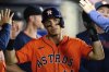 Houston Astros' Mauricio Dubón celebrates with teammates after scoring on a wild pitch during the 10th inning of a baseball game against the Los Angeles Angels, Friday, June 20, 2025, in Anaheim, Calif. (AP Photo/William Liang)