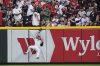 Cincinnati Reds right fielder Jake Fraley (27) falls into the wall after catching a fly ball hit by New York Yankees' Paul Goldschmidt during the fifth inning of a baseball game, Monday, June 23, 2025, in Cincinnati. (AP Photo/Joshua A. Bickel)