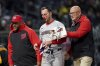 FILE - Washington Nationals' Paul DeJong, center, is helped off the field after getting hit by a pitch by Pittsburgh Pirates' Mitch Keller during the sixth inning of a baseball game Tuesday, April 15, 2025, in Pittsburgh. (AP Photo/Matt Freed,File)