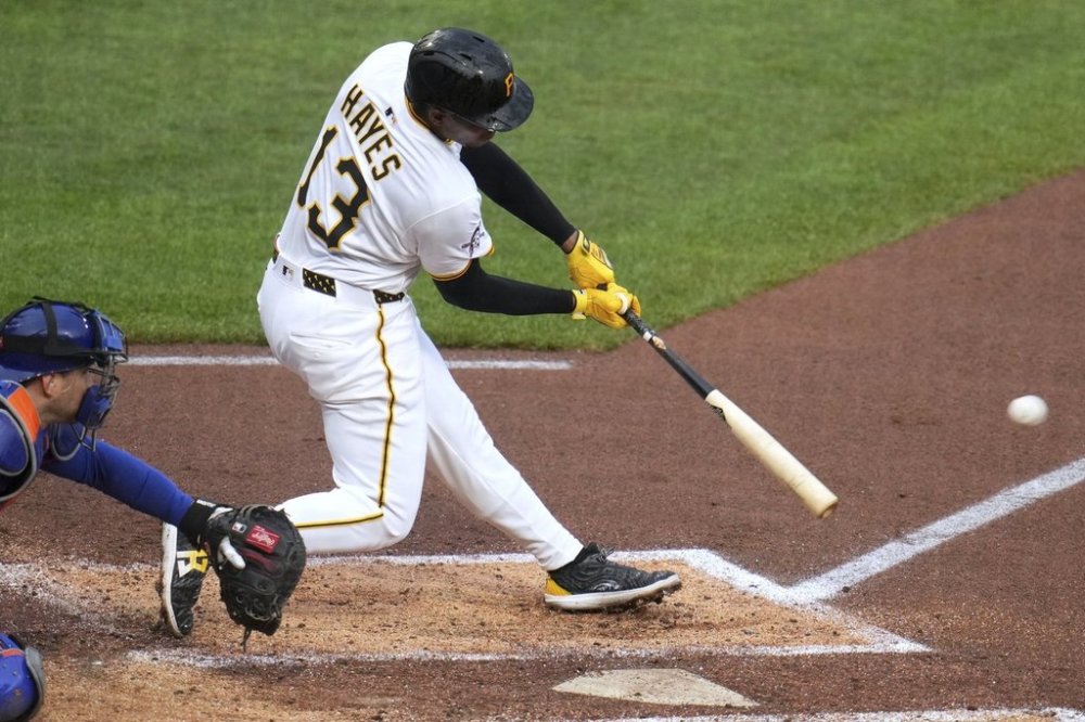 Pittsburgh Pirates' Ke'Bryan Hayes (13) singles off New York Mets pitcher Paul Blackburn, driving in a run, during the second inning of a baseball game in Pittsburgh, Saturday, June 28, 2025. (AP Photo/Gene J. Puskar)