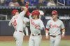 Philadelphia Phillies' Bryson Stott, center, celebrates with J.T. Realmuto (10) and Max Kepler after hitting a three-run home run during the fourth inning of a baseball game against the Miami Marlins, Wednesday, June 18, 2025, in Miami. (AP Photo/Marta Lavandier)