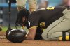San Diego Padres' Fernando Tatis Jr. kneels on the ground after being hit by a pitch during the ninth inning of a baseball game against the Los Angeles Dodgers, Thursday, June 19, 2025, in Los Angeles. (AP Photo/Mark J. Terrill)